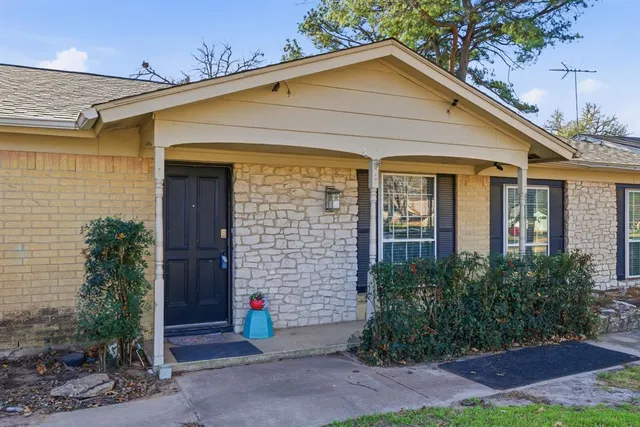 a view of brick house with plants