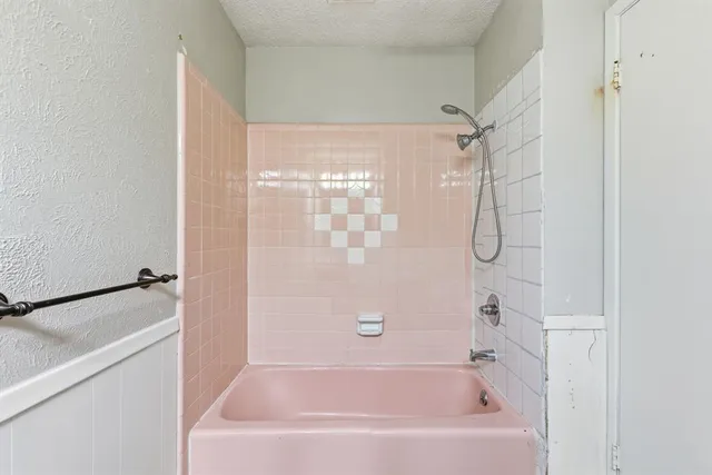 a bathroom with a shower and a bath tub