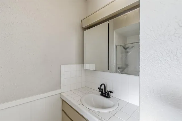 a bathroom with a sink and mirror