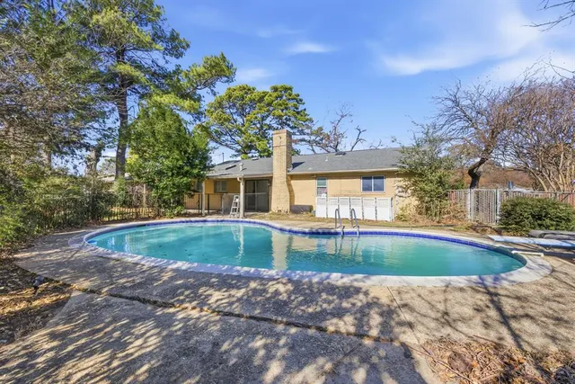 a view of a backyard with a floor to ceiling window next to a yard