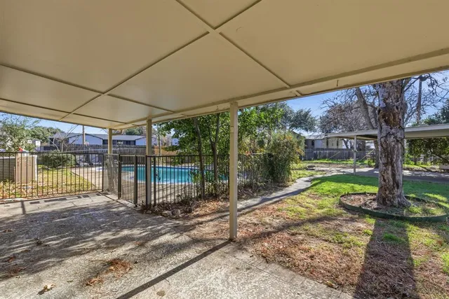 a view of a house with a tree and yard