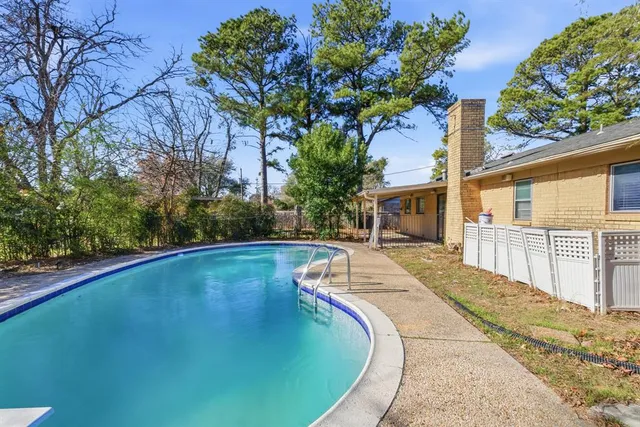 a view of a swimming pool with an outdoor seating