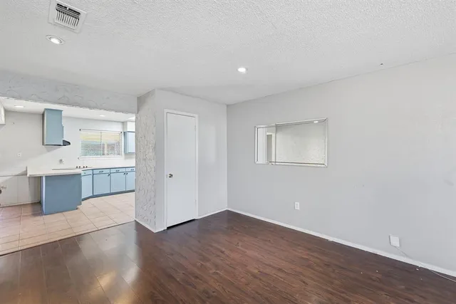 a view of a kitchen with a sink and a refrigerator