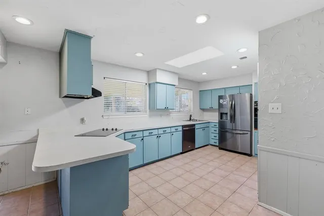 a kitchen with a sink cabinets and stainless steel appliances
