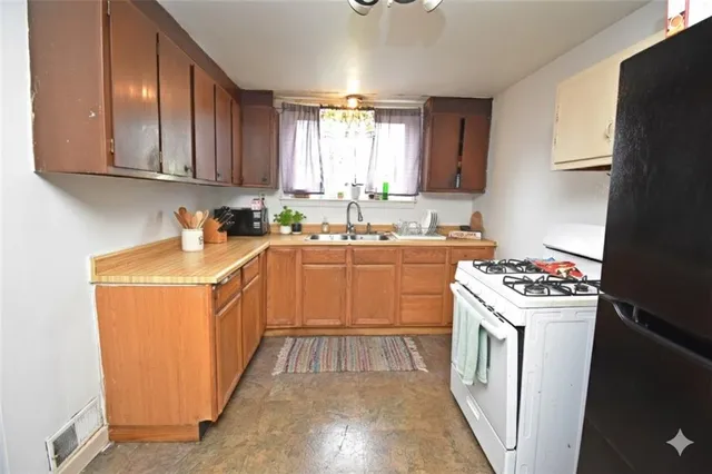 a kitchen that has a sink and a stove in it