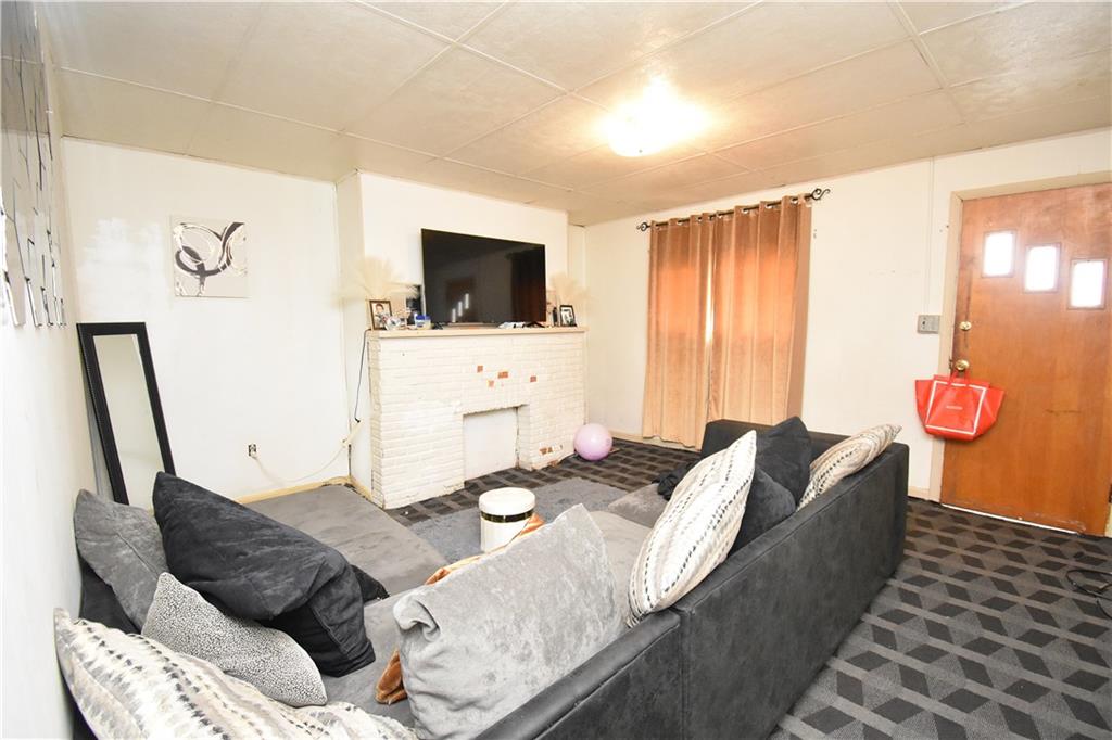 2118 Elsie Street Pittsburgh, PA 15210 - Photo 6 of 12 a living room with furniture and a flat screen tv