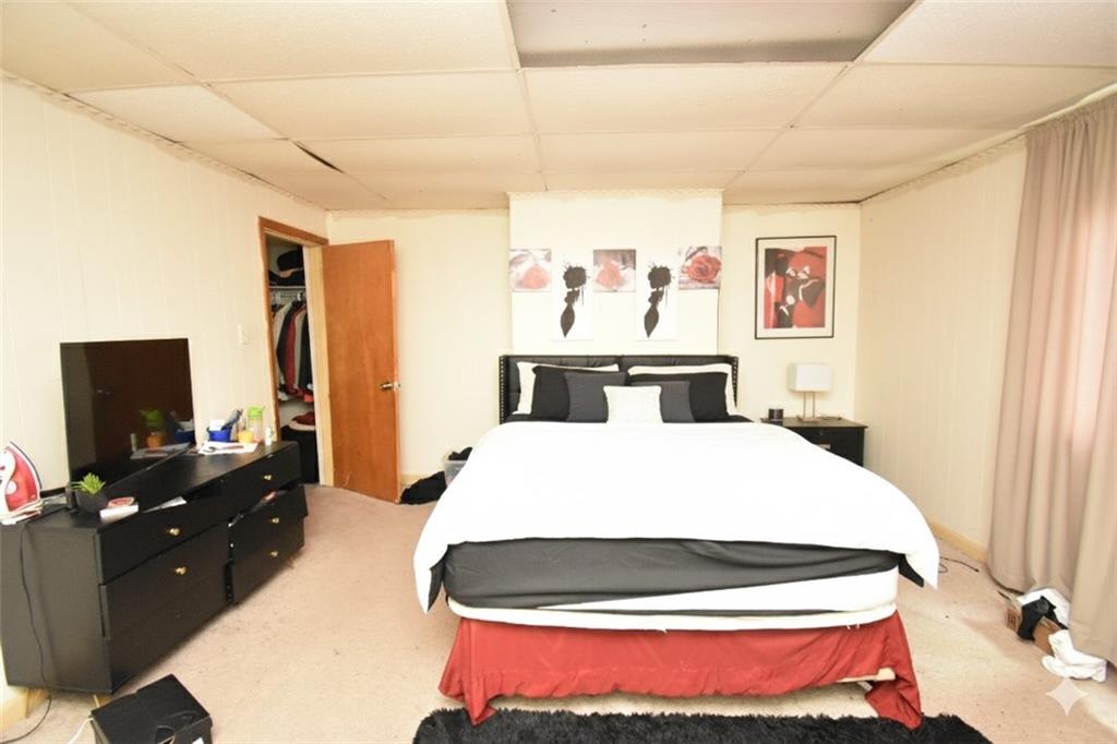 2118 Elsie Street Pittsburgh, PA 15210 - Photo 8 of 12 a bedroom with a bed and a flat screen tv