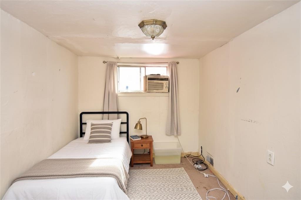 2118 Elsie Street Pittsburgh, PA 15210 - Photo 9 of 12 a bedroom with a bed and window