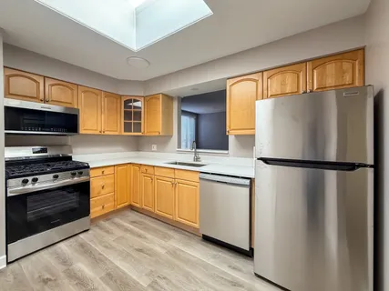 a kitchen with stainless steel appliances a refrigerator sink and microwave