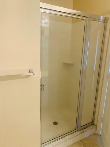 a bathroom with a glass shower door