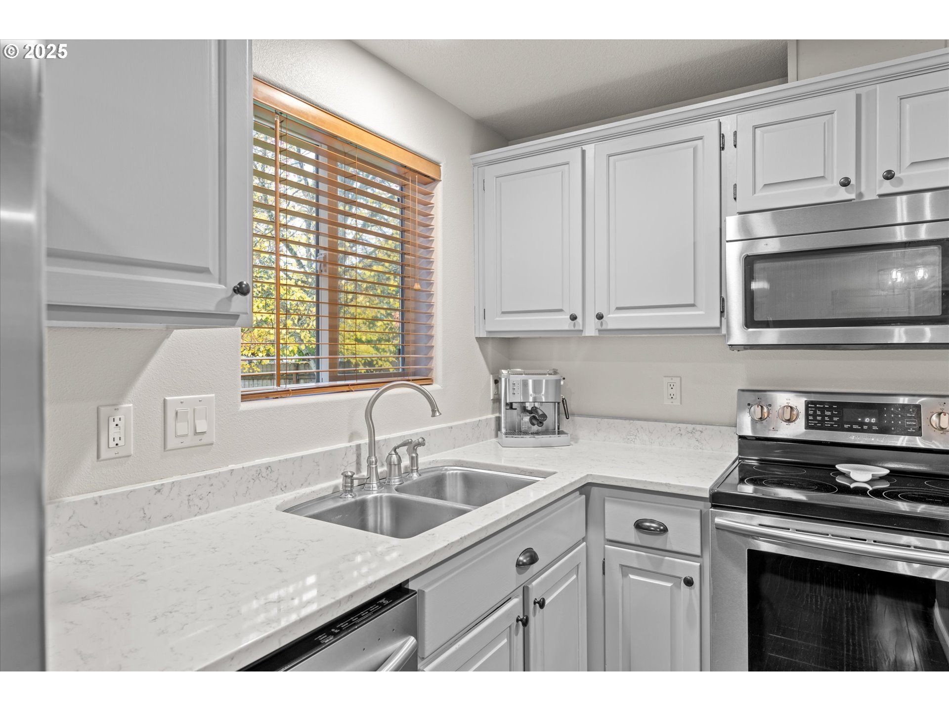 3019 Brooke Street Forest Grove, OR 97116 - Photo 12 of 34 a kitchen with stainless steel appliances granite countertop a sink a stove and a microwave