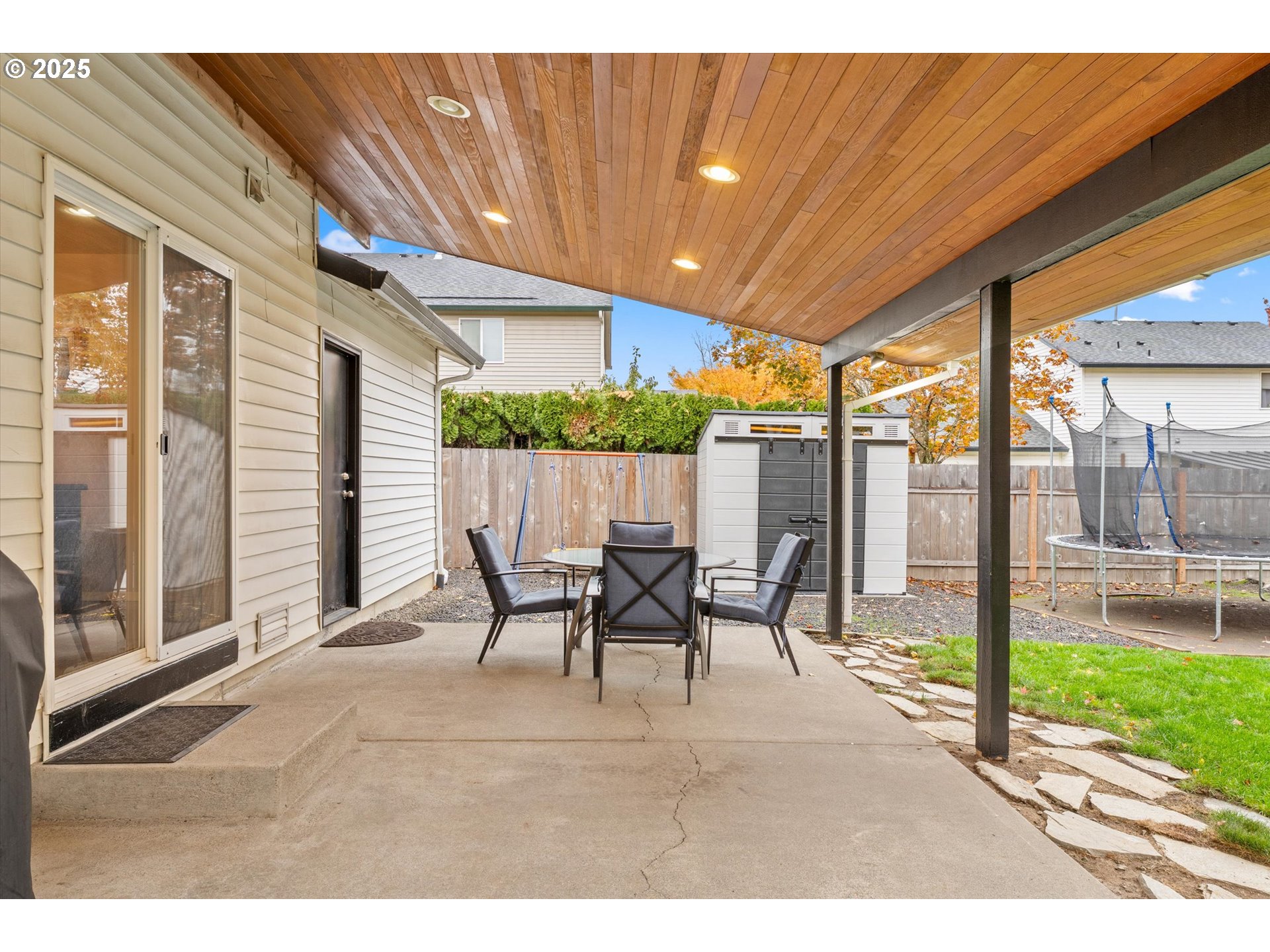 3019 Brooke Street Forest Grove, OR 97116 - Photo 24 of 34 a view of a patio with table and chairs and floor to ceiling window