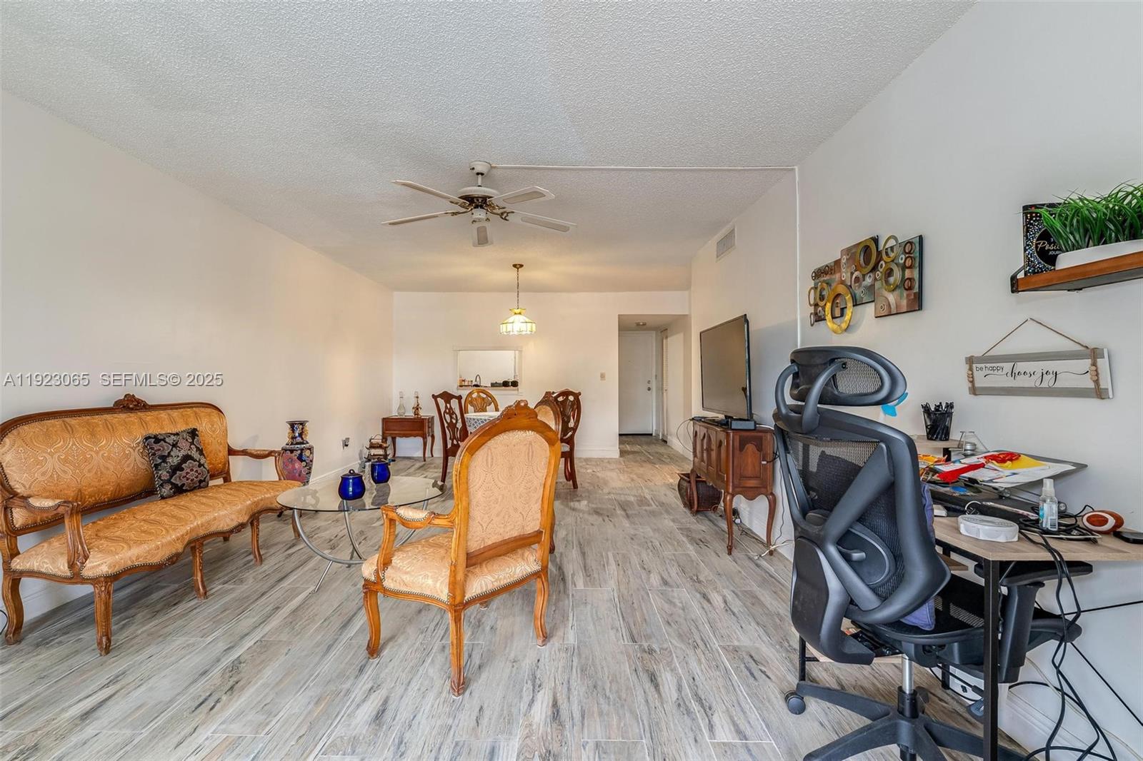 2840 Somerset Drive, Unit 207M Lauderdale Lakes, FL 33311 - Photo 13 of 25 a living room with furniture and a wooden floor