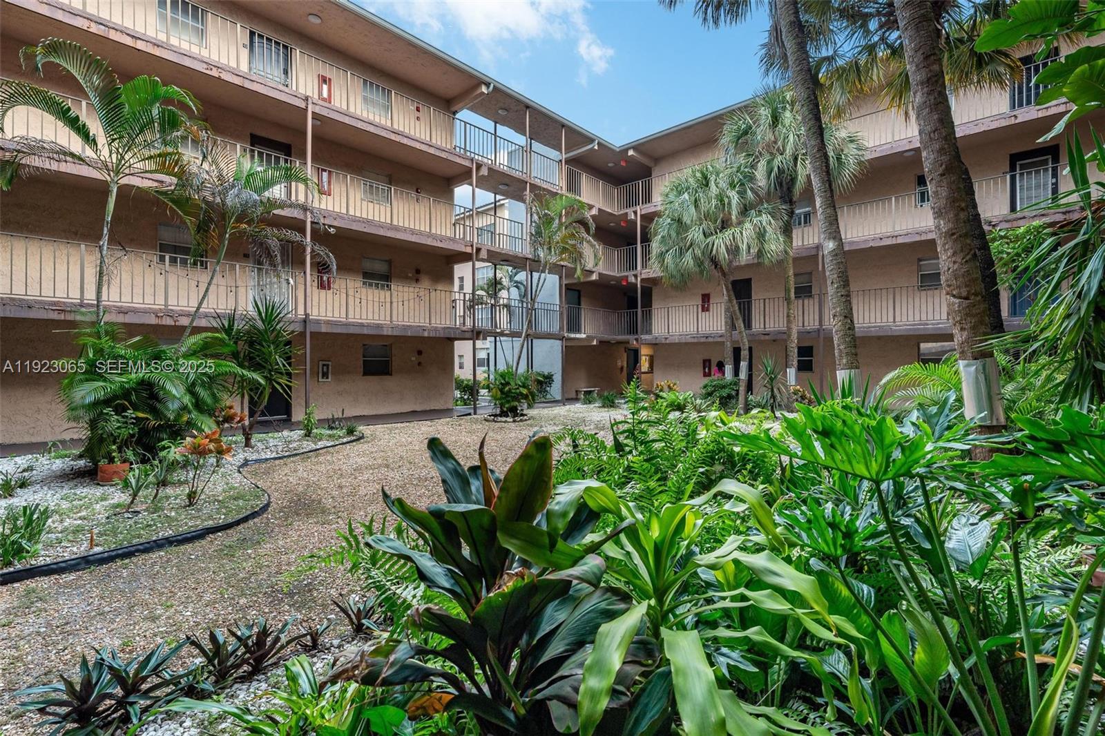 2840 Somerset Drive, Unit 207M Lauderdale Lakes, FL 33311 - Photo 2 of 25 a view of a building with a garden
