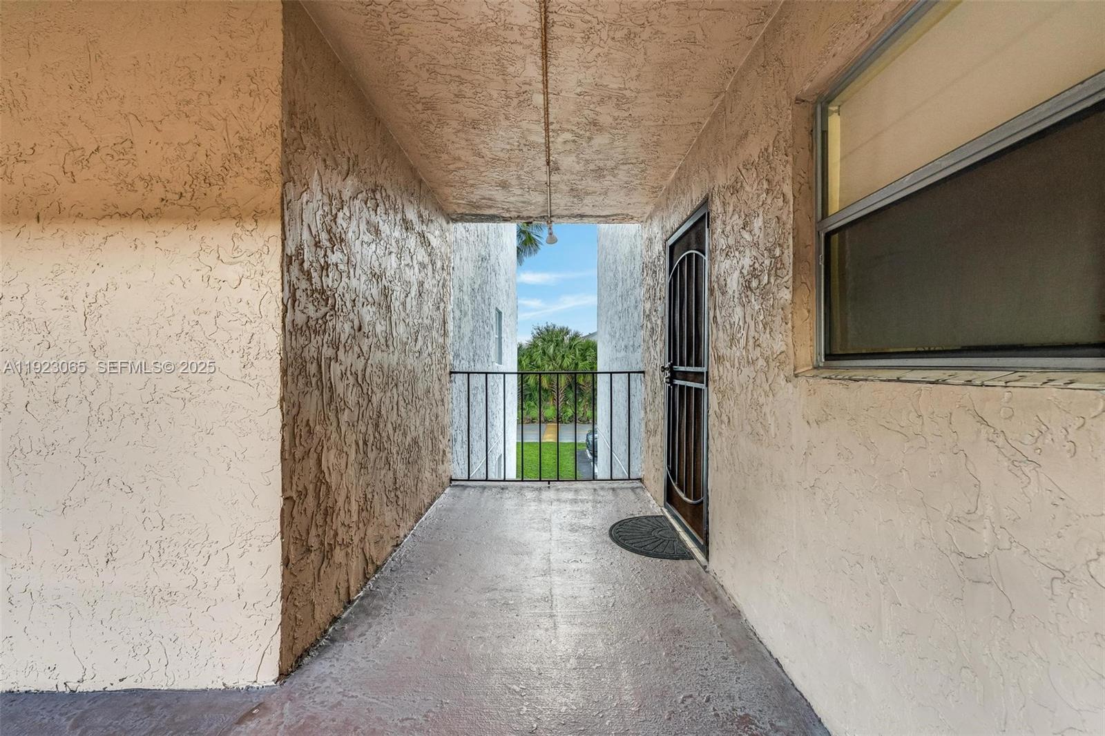 2840 Somerset Drive, Unit 207M Lauderdale Lakes, FL 33311 - Photo 23 of 25 a view of a room with a wooden door and brick walls