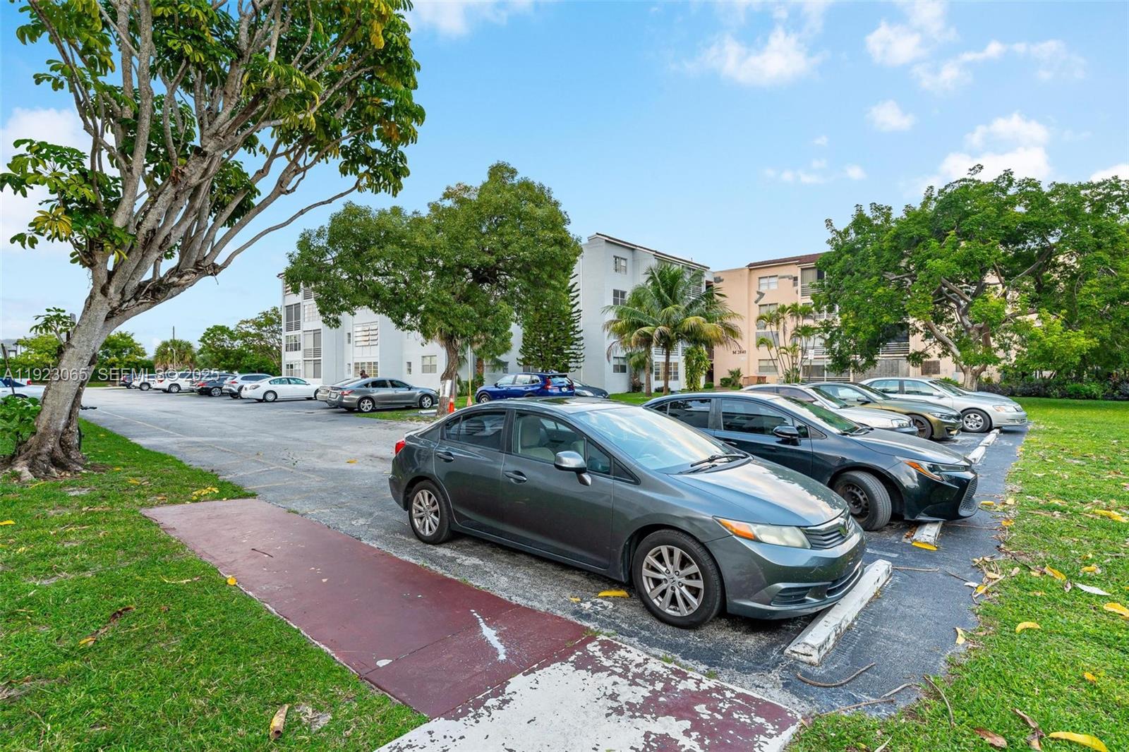 2840 Somerset Drive, Unit 207M Lauderdale Lakes, FL 33311 - Photo 8 of 25 a view of a car parked in front of a house