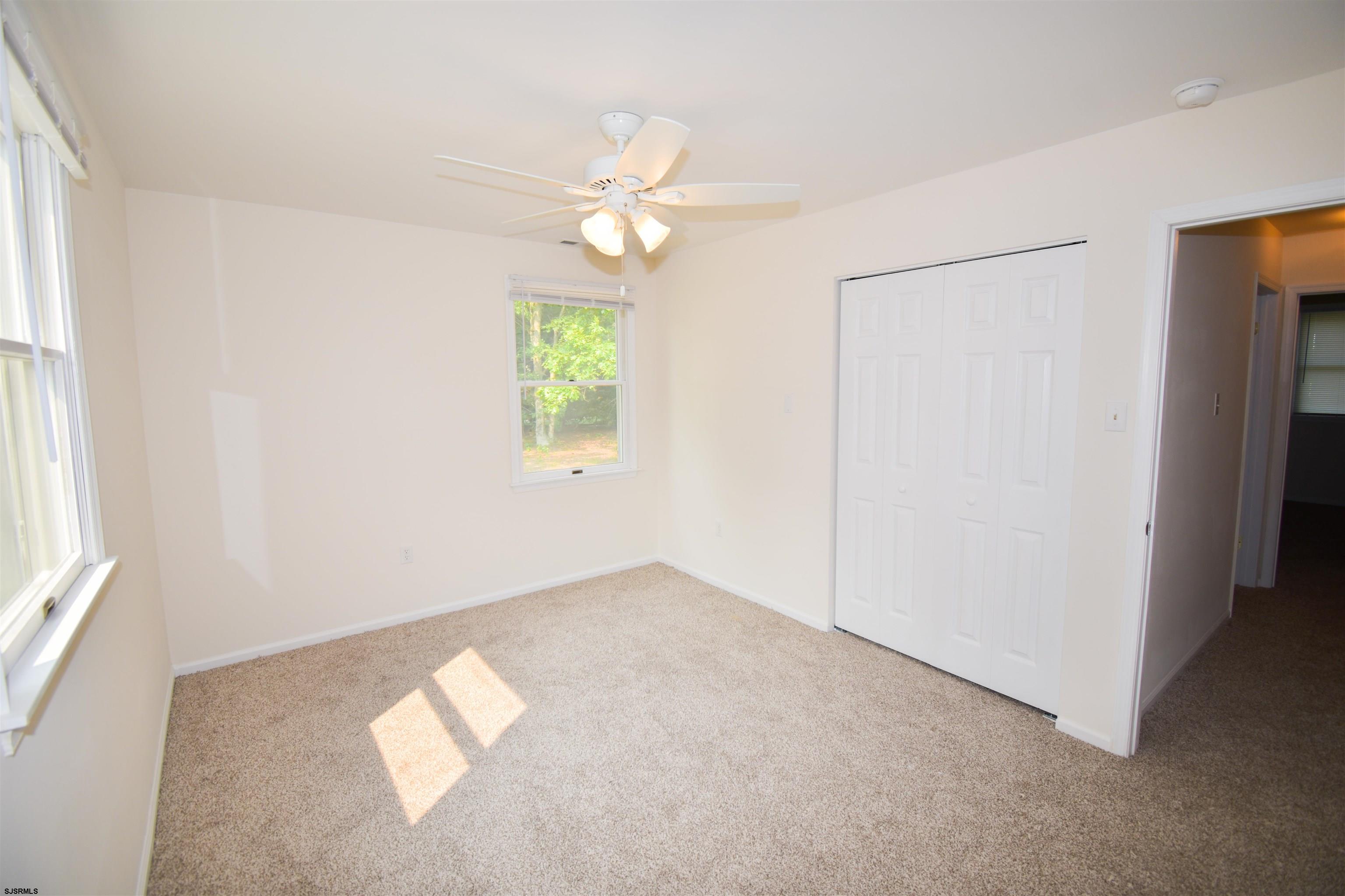 600 Stagecoach Road Marmora, NJ 08223 - Photo 14 of 29 an empty room with windows and fan