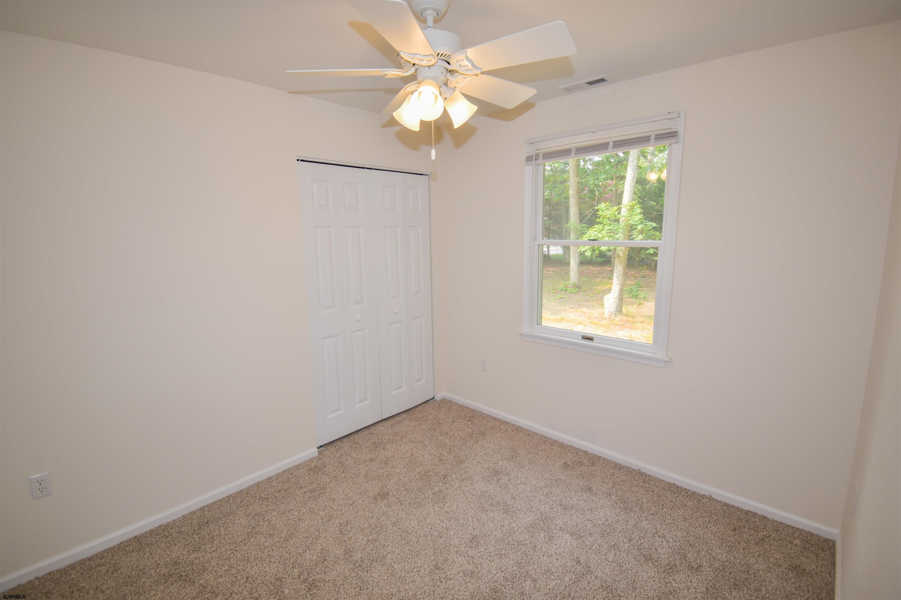 600 Stagecoach Road Marmora, NJ 08223 - Photo 15 of 29 an empty room with a window and a fan