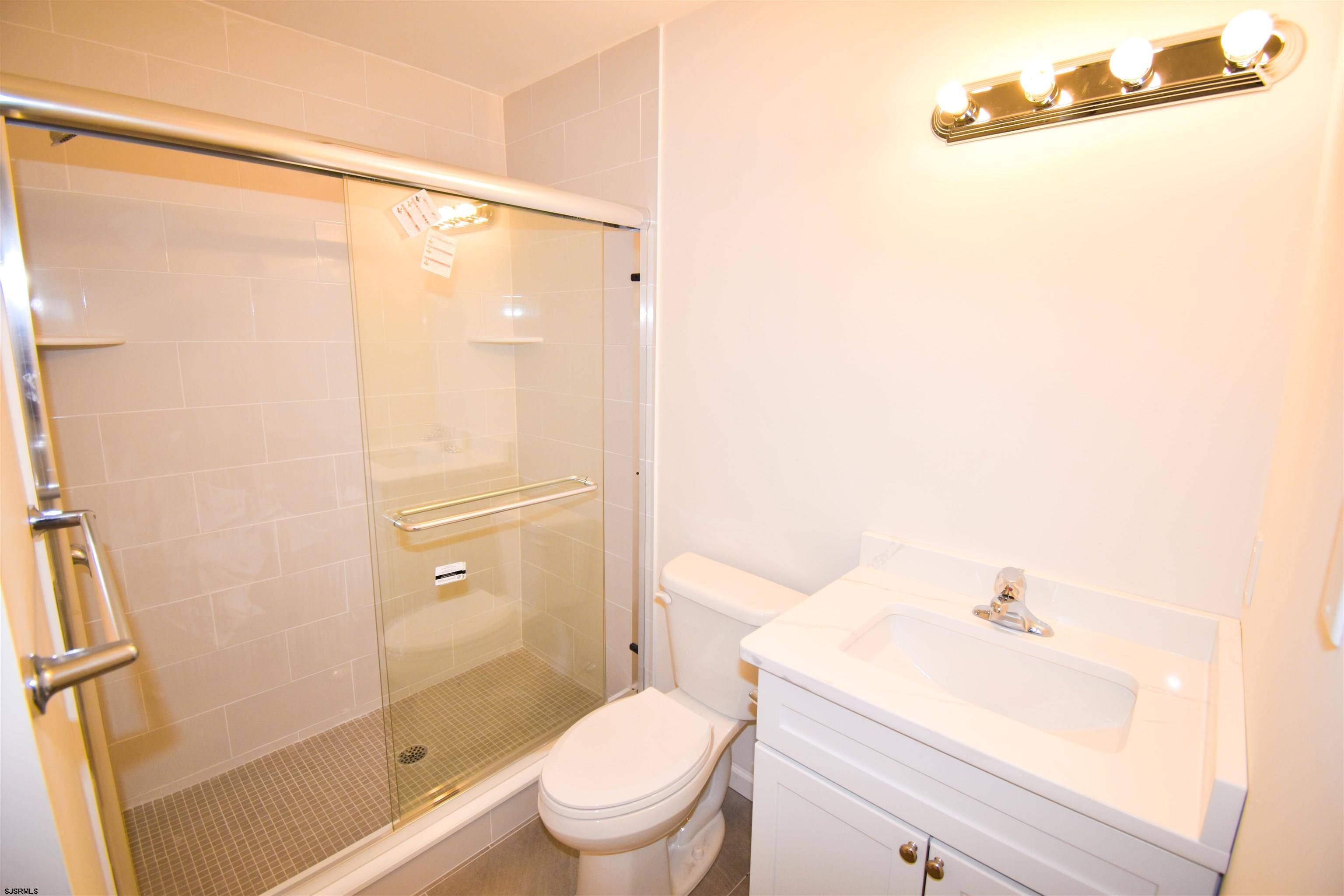 600 Stagecoach Road Marmora, NJ 08223 - Photo 19 of 29 a bathroom with a shower a toilet and a sink