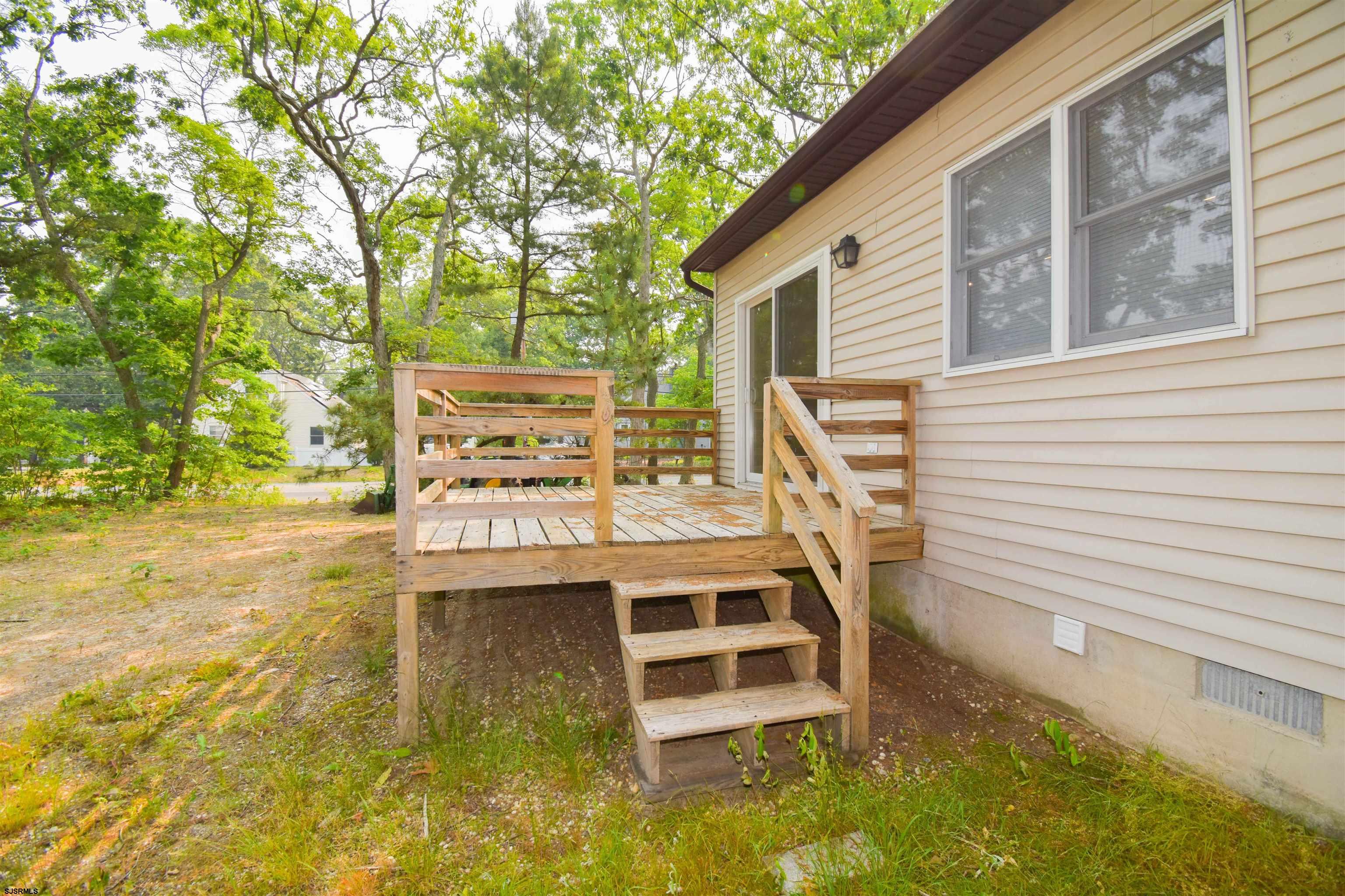 600 Stagecoach Road Marmora, NJ 08223 - Photo 22 of 29 a backyard of a house with table and chairs