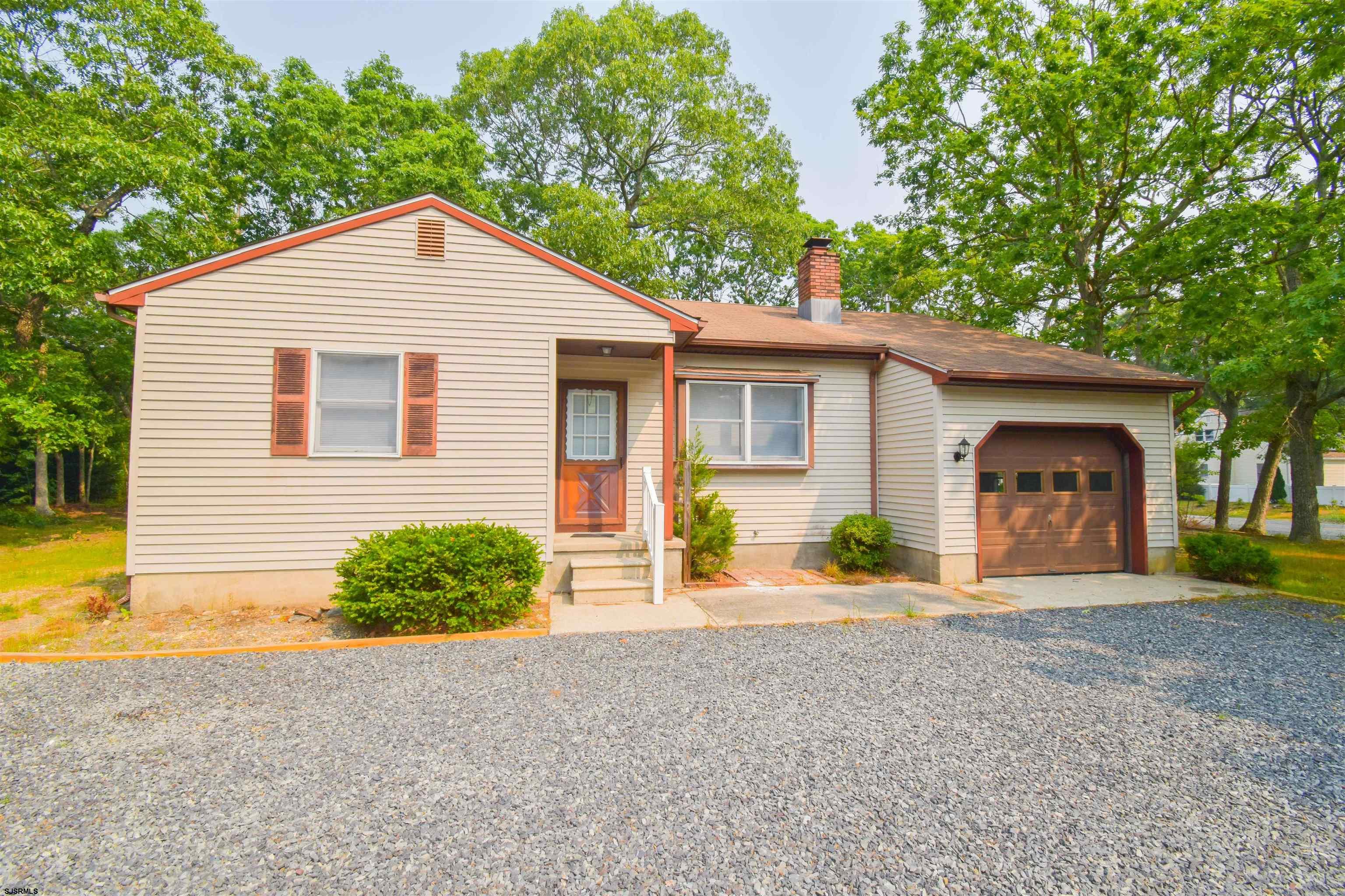 600 Stagecoach Road Marmora, NJ 08223 - Photo 28 of 29 a front view of a house with a yard and garage