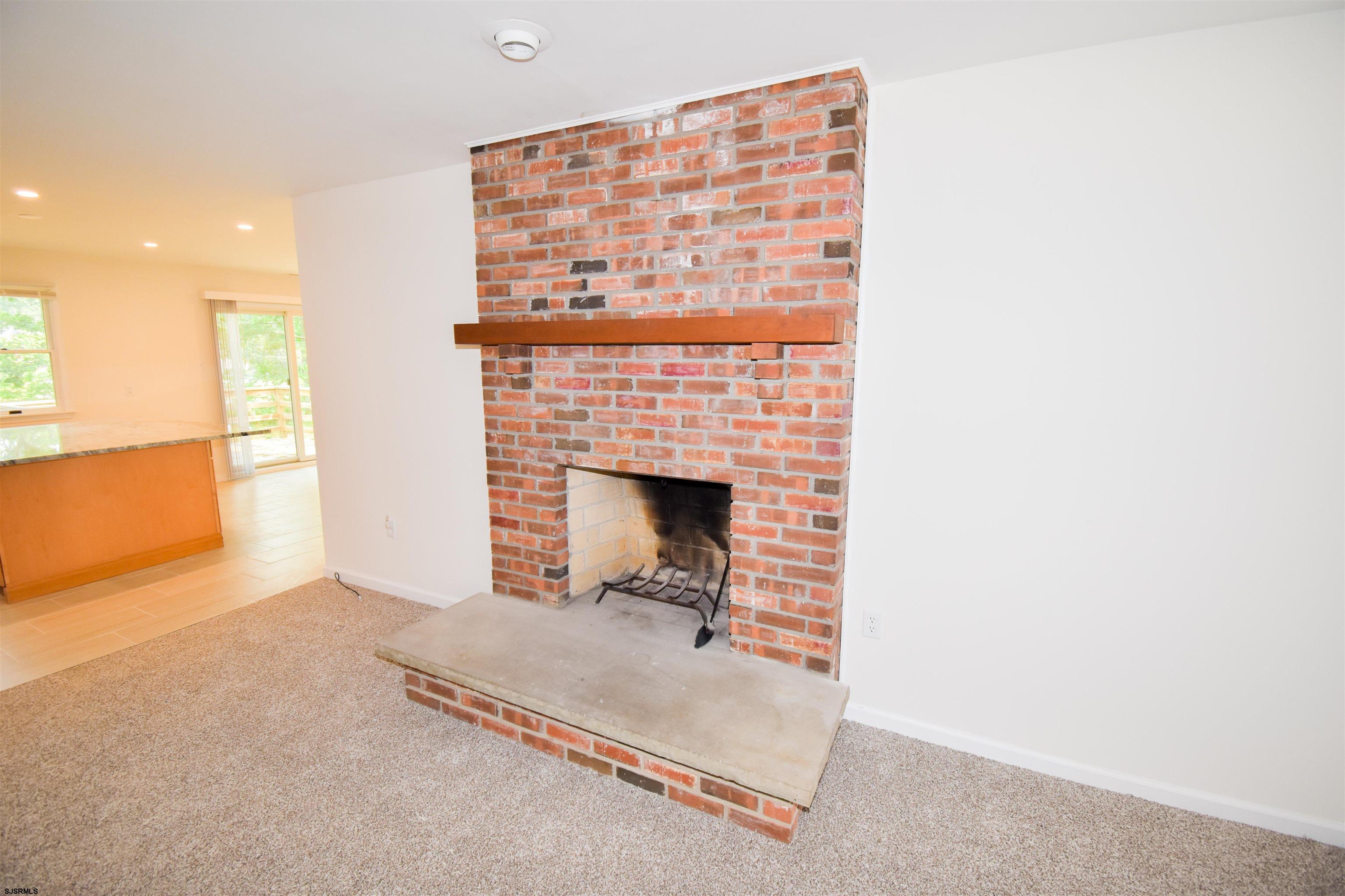 600 Stagecoach Road Marmora, NJ 08223 - Photo 3 of 29 a living room with a rug and a fireplace