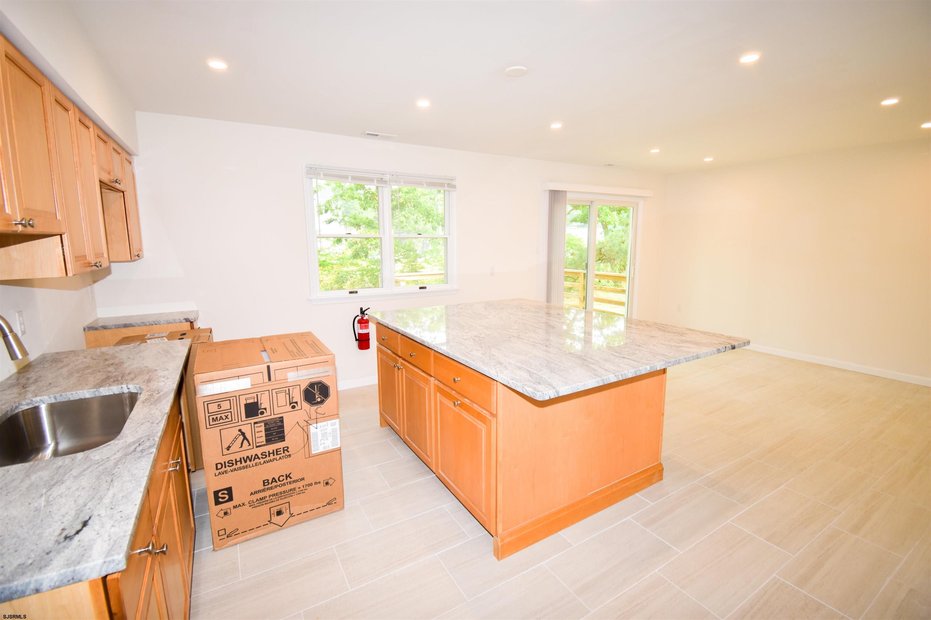 600 Stagecoach Road Marmora, NJ 08223 - Photo 5 of 29 a kitchen with stainless steel appliances granite countertop a sink and a stove