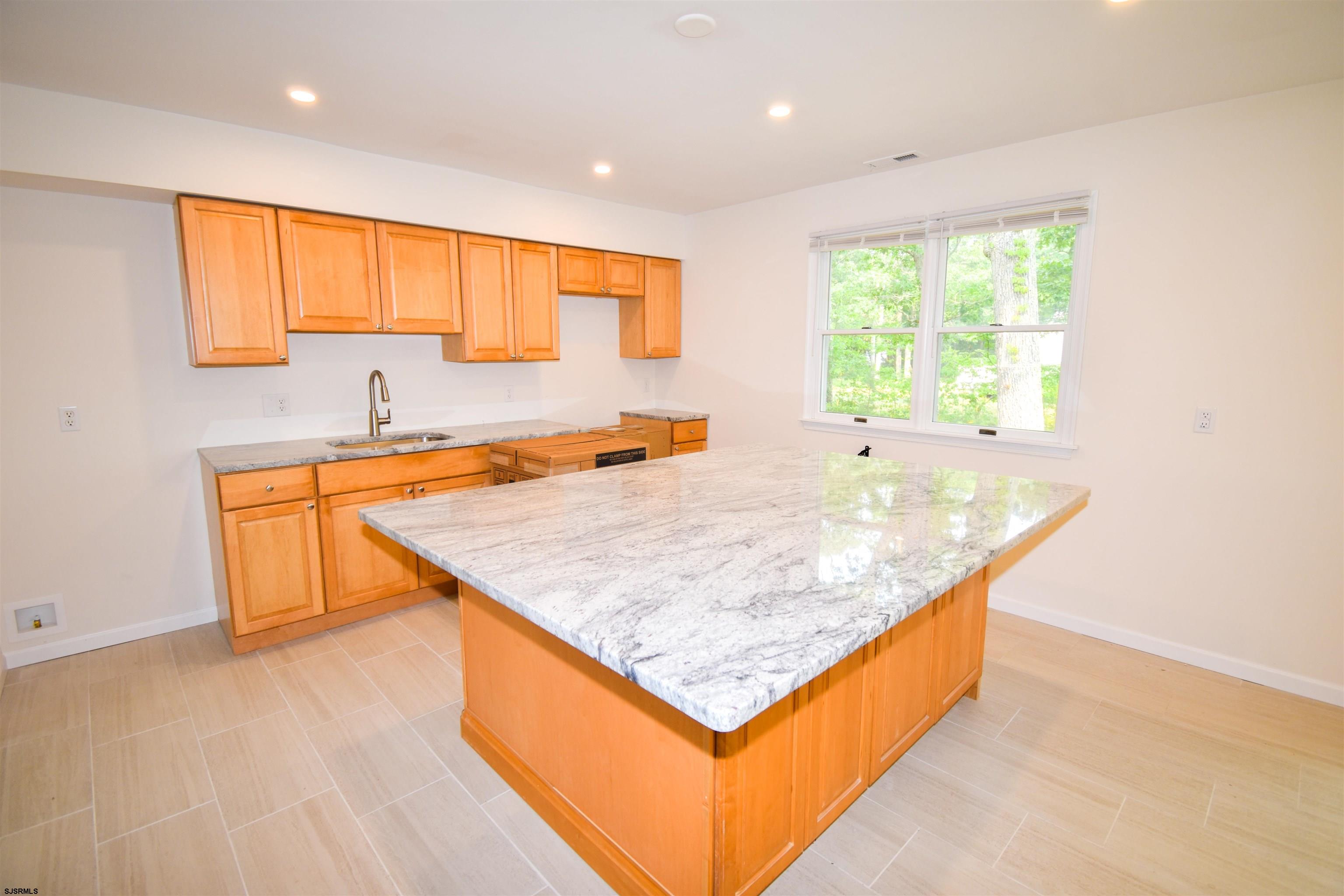 600 Stagecoach Road Marmora, NJ 08223 - Photo 6 of 29 a kitchen with stainless steel appliances granite countertop a sink a stove and a wooden floors