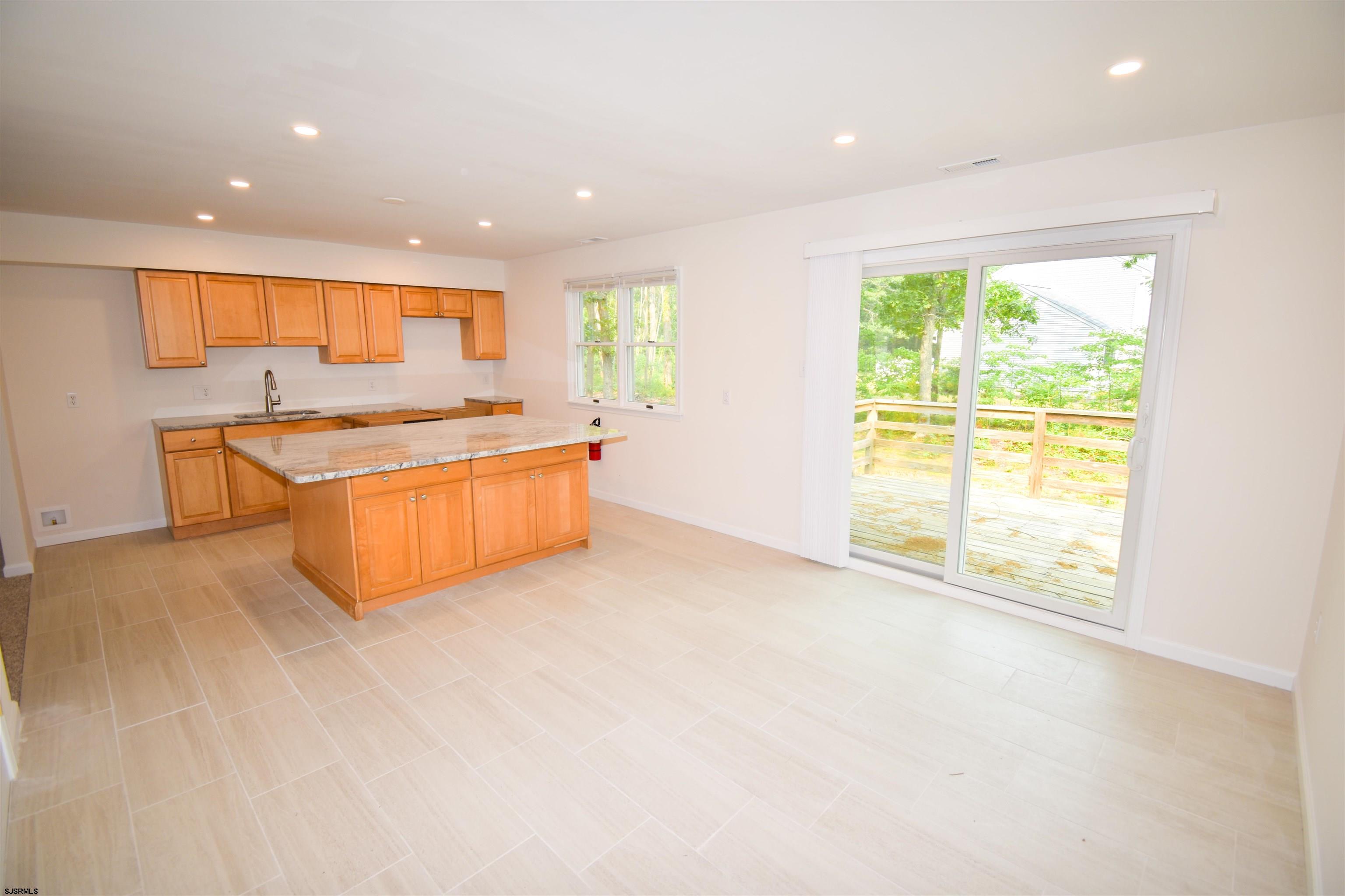 600 Stagecoach Road Marmora, NJ 08223 - Photo 7 of 29 a view of a kitchen with stainless steel appliances granite countertop a large window