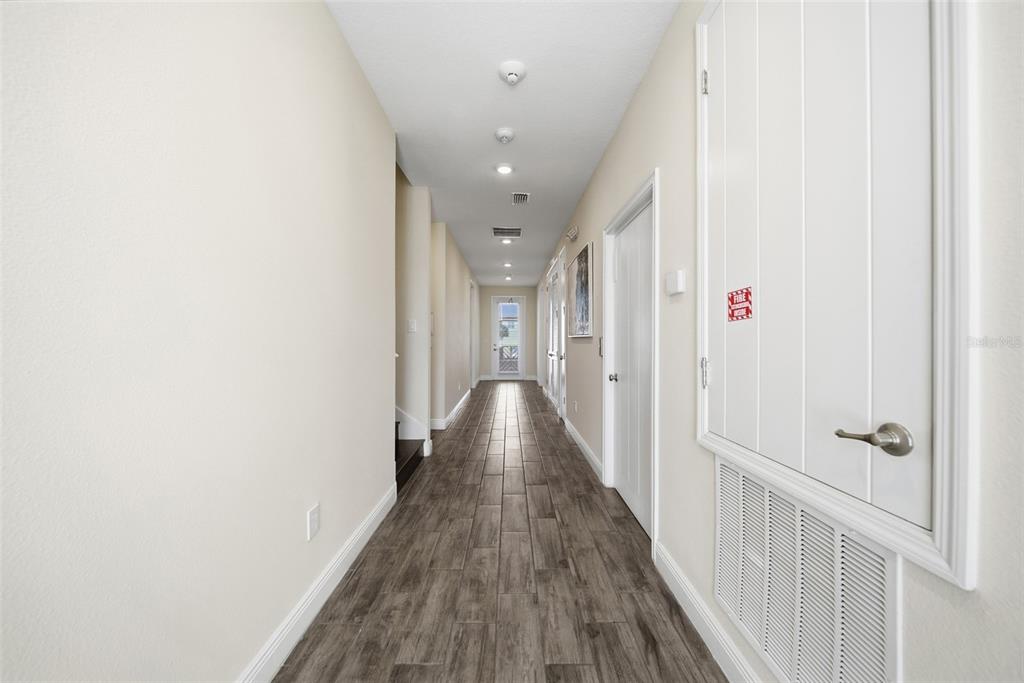 8017 Surf Street Kissimmee, FL 34747 - Photo 11 of 64 a view of a hallway with wooden floor and staircase