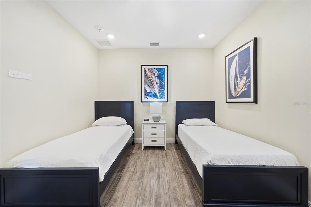 8017 Surf Street Kissimmee, FL 34747 - Photo 12 of 64 a bedroom with double bed and two large window