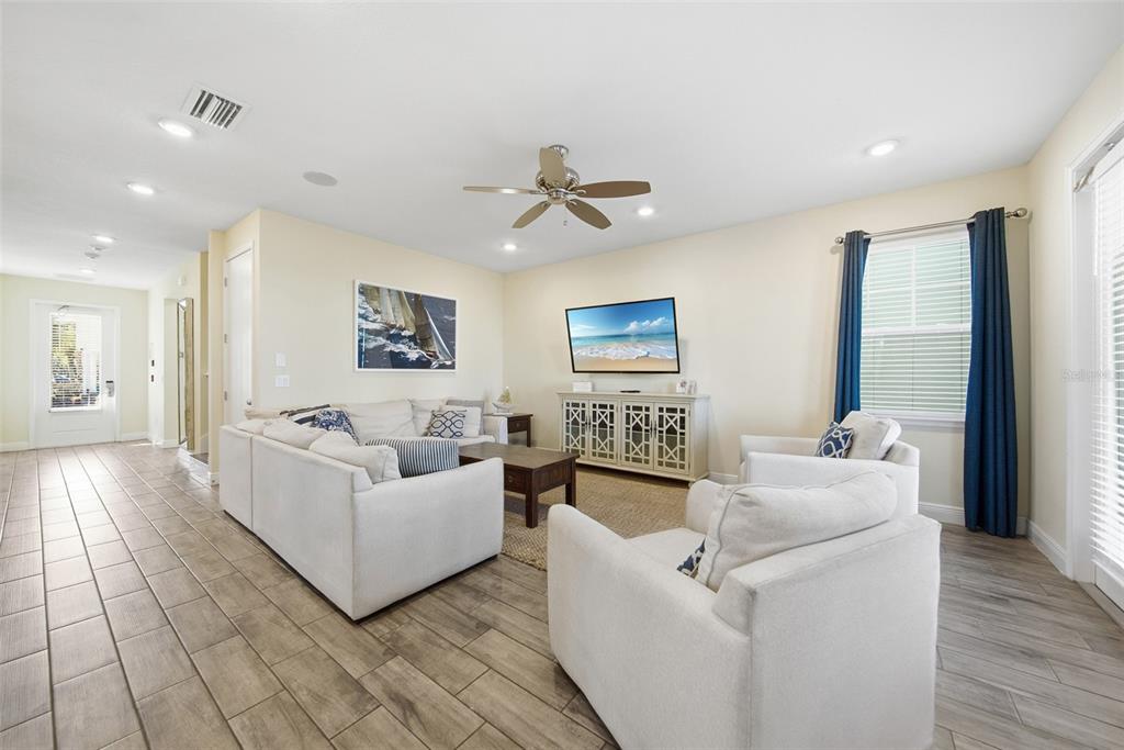 8017 Surf Street Kissimmee, FL 34747 - Photo 14 of 64 a living room with furniture and a ceiling fan
