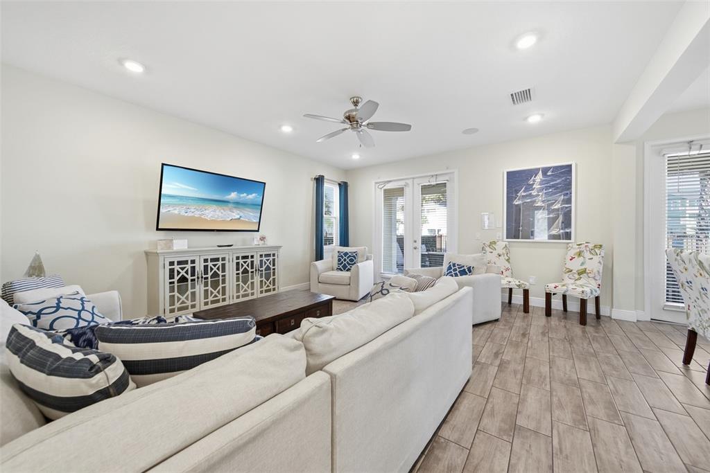 8017 Surf Street Kissimmee, FL 34747 - Photo 16 of 64 a living room with furniture and a wooden floor