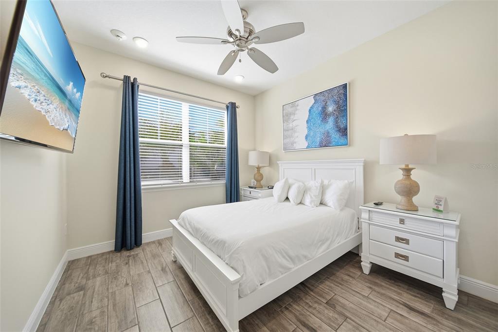 8017 Surf Street Kissimmee, FL 34747 - Photo 22 of 64 a bedroom with a large bed and a window