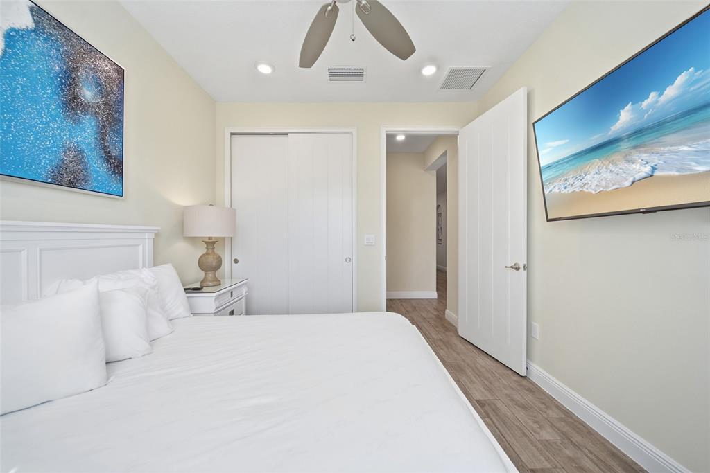 8017 Surf Street Kissimmee, FL 34747 - Photo 23 of 64 a bedroom with a large bed and a chandelier