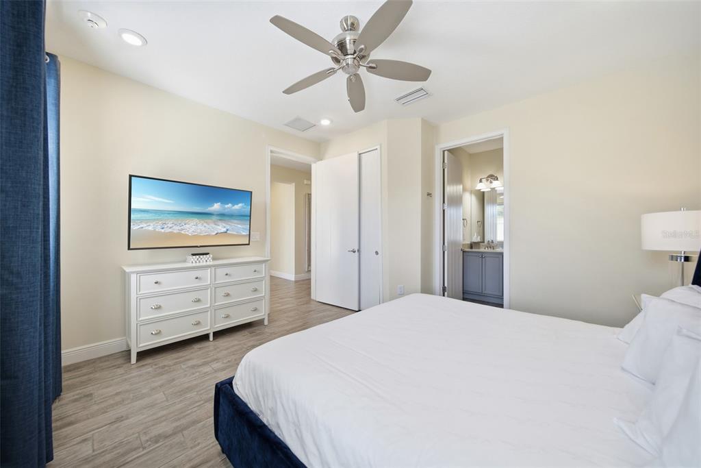 8017 Surf Street Kissimmee, FL 34747 - Photo 25 of 64 a bedroom with a bed and a flat screen tv