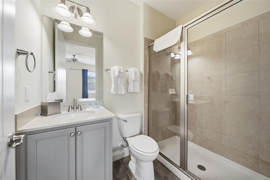 8017 Surf Street Kissimmee, FL 34747 - Photo 26 of 64 a bathroom with a sink a toilet and shower
