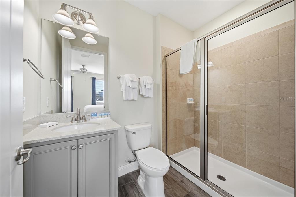 8017 Surf Street Kissimmee, FL 34747 - Photo 27 of 64 a bathroom with a sink vanity mirror and toilet