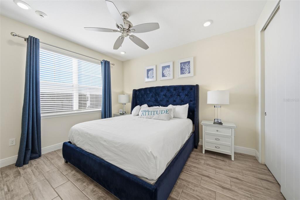 8017 Surf Street Kissimmee, FL 34747 - Photo 28 of 64 a bedroom with a bed and a window