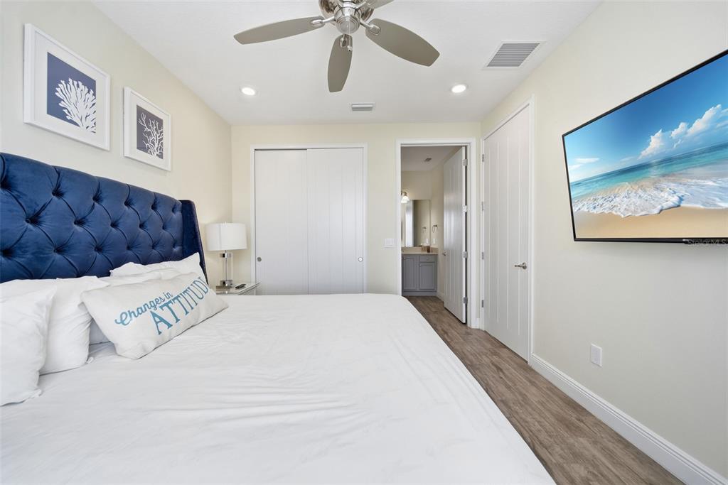 8017 Surf Street Kissimmee, FL 34747 - Photo 29 of 64 a bedroom with a large bed and a chandelier