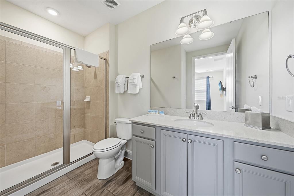 8017 Surf Street Kissimmee, FL 34747 - Photo 30 of 64 a bathroom with a double vanity sink toilet and shower