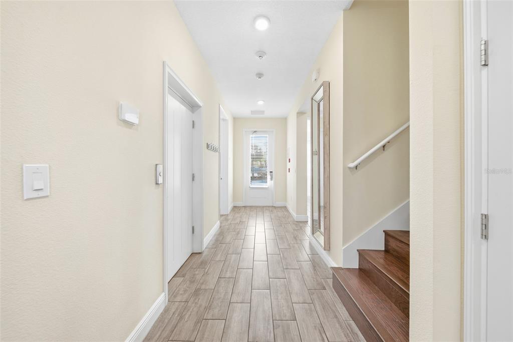 8017 Surf Street Kissimmee, FL 34747 - Photo 3 of 64 a view of hallway with wooden floor