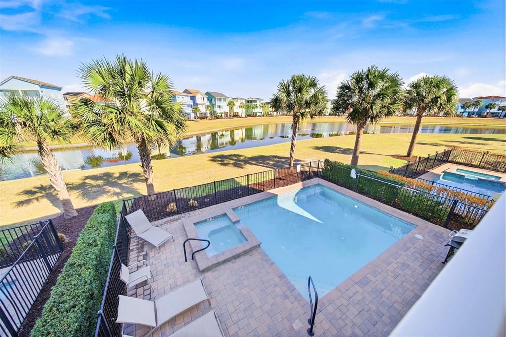 8017 Surf Street Kissimmee, FL 34747 - Photo 33 of 64 a view of a swimming pool with a lounge chairs