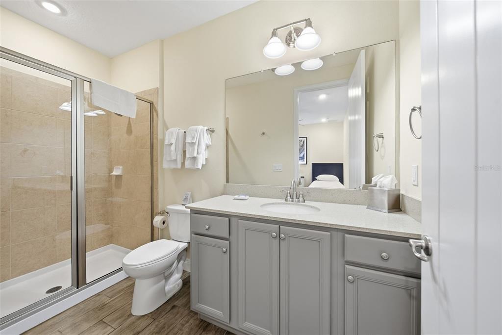 8017 Surf Street Kissimmee, FL 34747 - Photo 34 of 64 a view of bathroom with a sink mirror toilet and shower