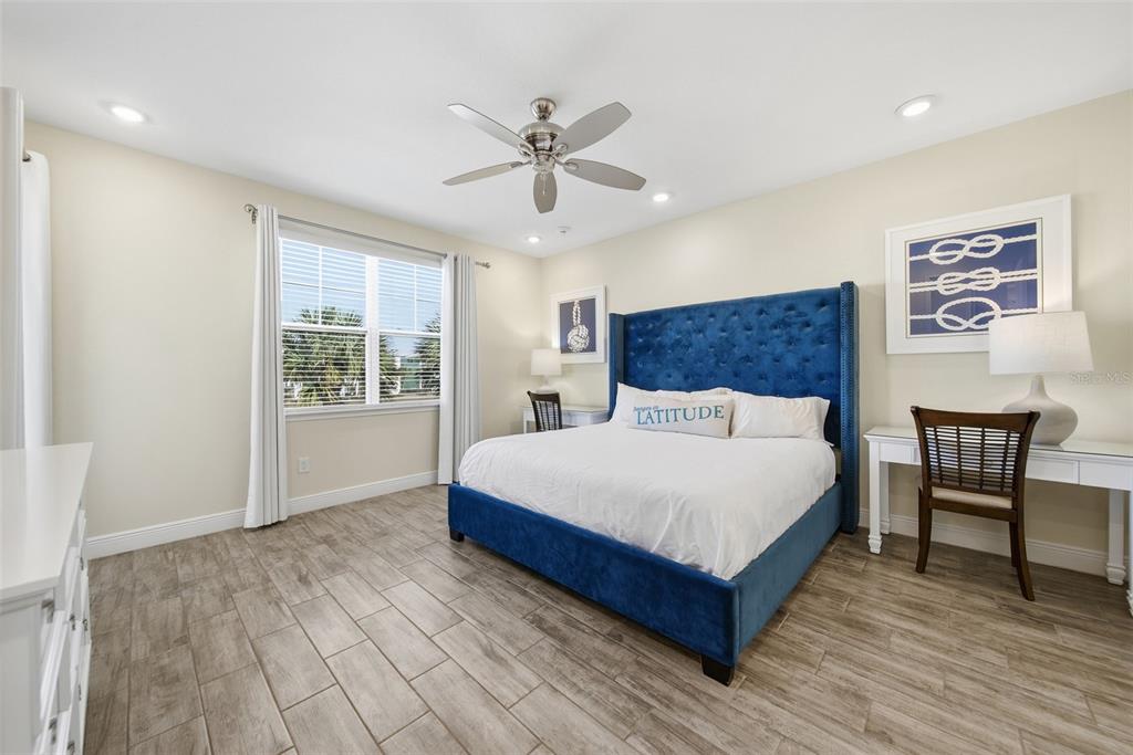 8017 Surf Street Kissimmee, FL 34747 - Photo 35 of 64 a spacious bedroom with a bed and a table