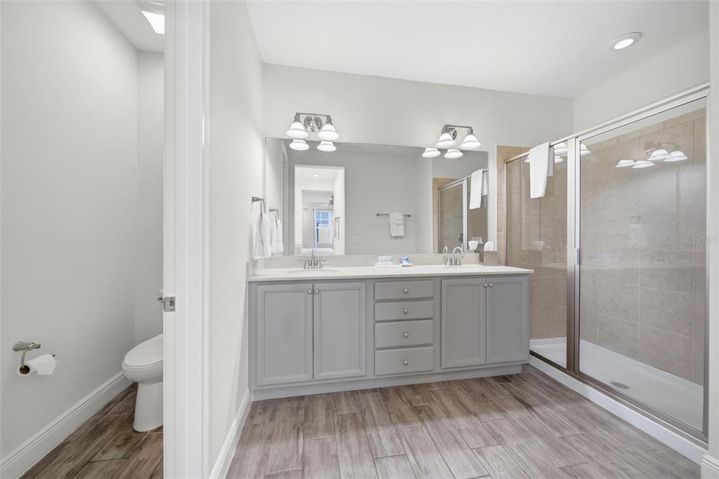 8017 Surf Street Kissimmee, FL 34747 - Photo 39 of 64 a bathroom with a sink a toilet and shower