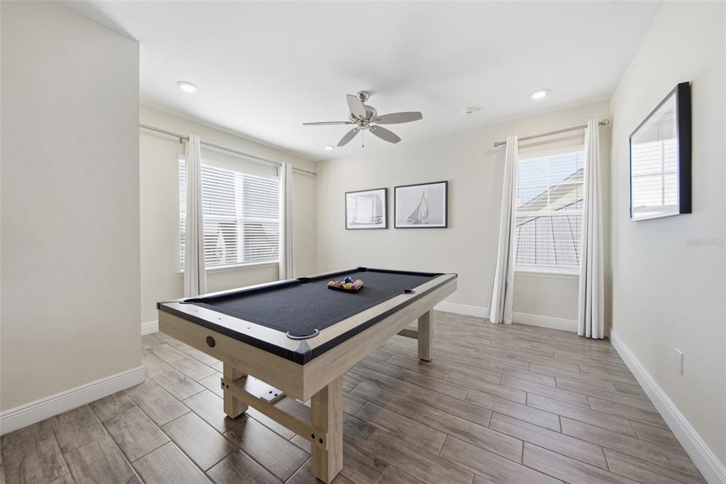 8017 Surf Street Kissimmee, FL 34747 - Photo 42 of 64 a room with wooden floor and window