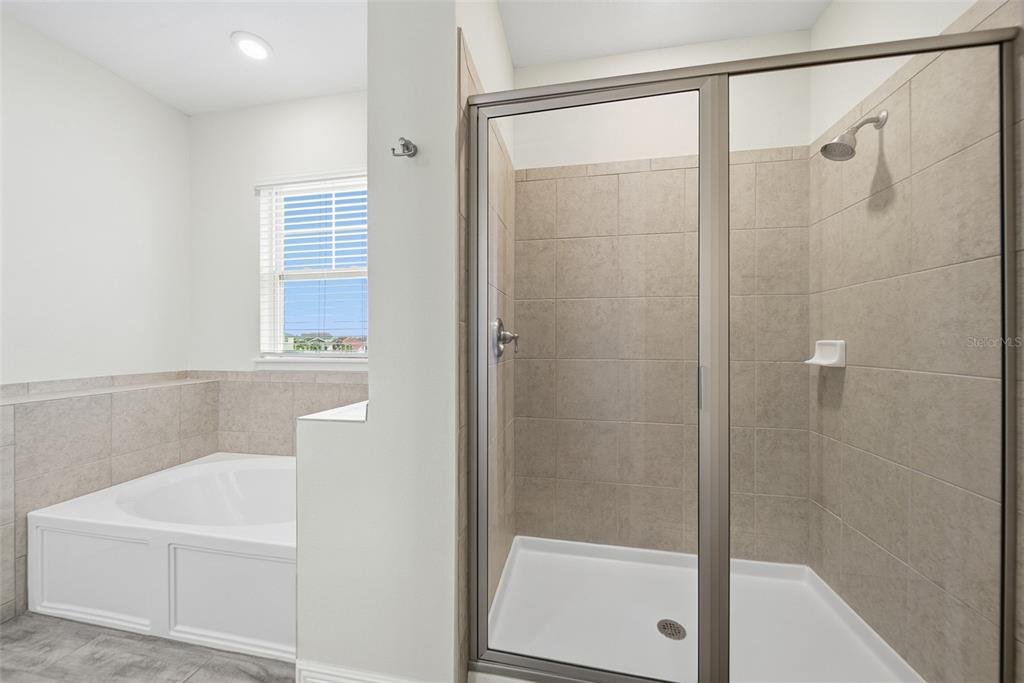 8017 Surf Street Kissimmee, FL 34747 - Photo 48 of 64 a bathroom with a white bath tub sitting next to a window