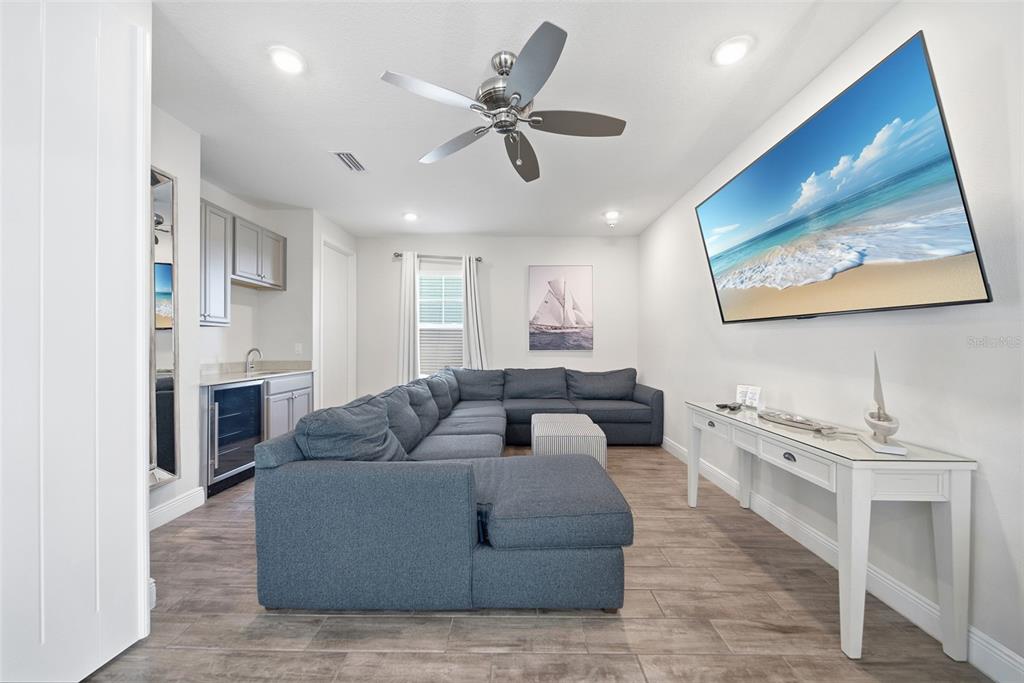 8017 Surf Street Kissimmee, FL 34747 - Photo 53 of 64 a living room with furniture kitchen view and a fireplace
