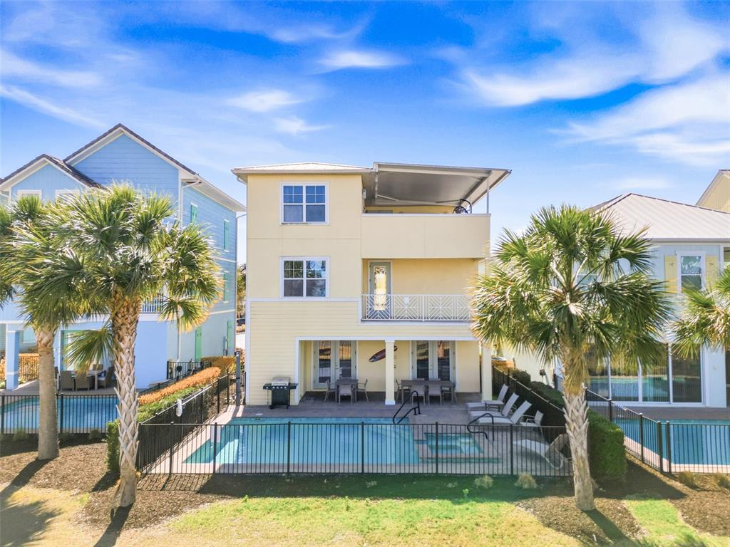 8017 Surf Street Kissimmee, FL 34747 - Photo 55 of 64 a view of a house with backyard and swimming pool